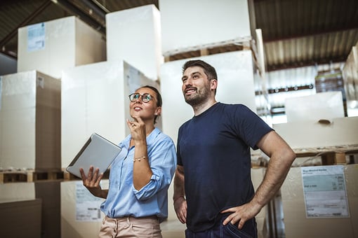 woman and man taking inventory in warehouse woman and man taking inventory in warehouse