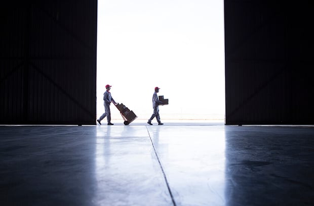 two people at a distance moving boxes two people at a distance moving boxes